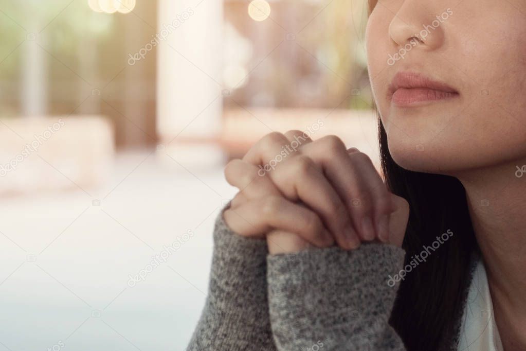 close up of young woman praying