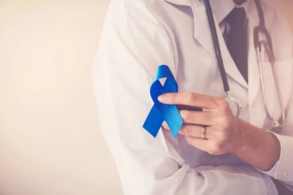 医師の手を保持ライトブルーリボン 前立腺癌の意識 — ストック写真