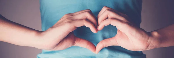 Donna mani facendo una forma di cuore sul suo stomaco, intestino sano d — Foto Stock