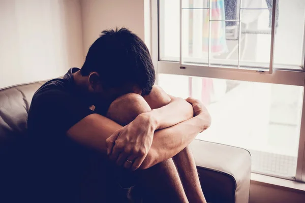 Depressed and anxiety young man sitting alone at home, mental he — Stock Photo, Image