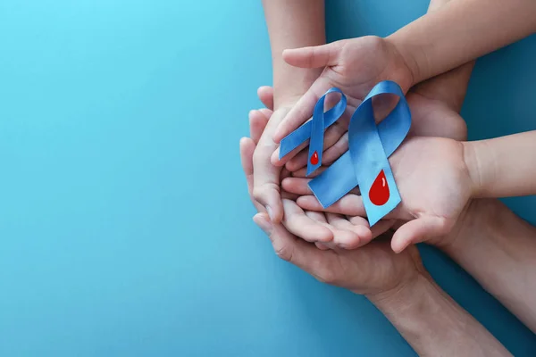 Light blue ribbons with blood on blue background , world diabete — Stock Photo, Image