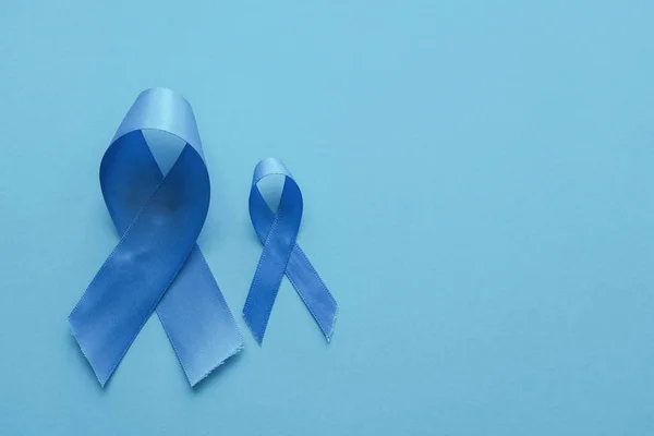 Light blue ribbons on blue background , Prostate Cancer Awarenes — ストック写真