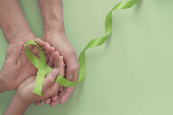 Adult Child Hands Holding Lime Green Ribbon Green Background Children — Stock Photo, Image