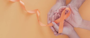 Yetişkin ve çocuk elleri turuncu kurdele, lösemi kanseri ve çoklu skleroz, KOAH ve ADHD farkındalığı, dünya böbrek günü