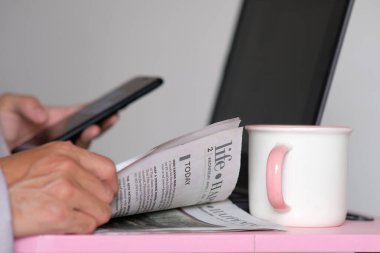 Dizüstü bilgisayar ve akıllı telefon üzerinde çalışan iş adamı