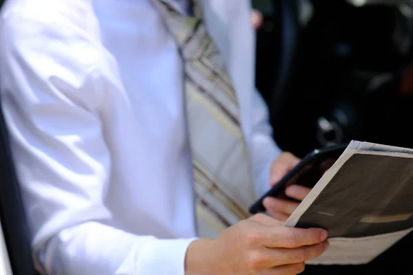 businessman using a smartphone and reading business news