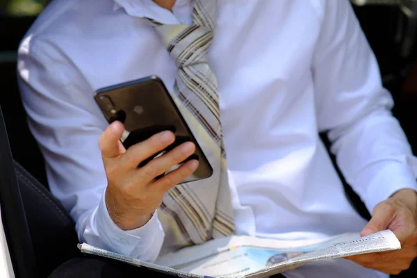 businessman using a smartphone and reading business news