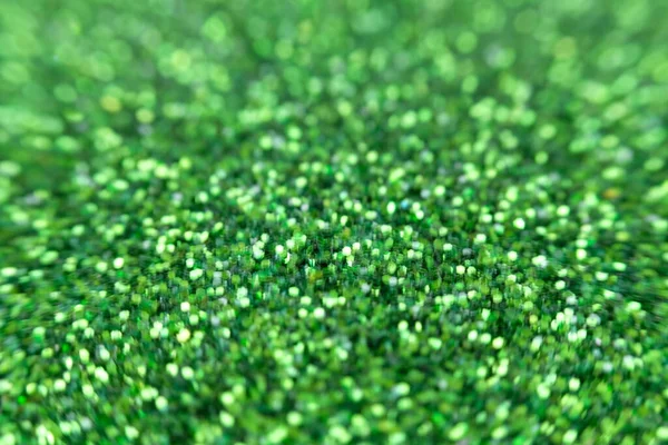 Green glitter surface with green light bokeh and Blurred abstract holiday background