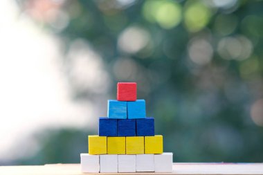 Ahşap küpler merdiven gibi istiflenir. İş konsepti büyüme süreci ve masa arkası ve takım çalışması konseptine iş kelimesi