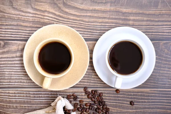 古い木のテーブルの上のコーヒーカップとコーヒー豆背景 — ストック写真