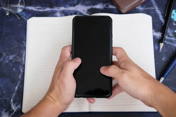 open notebook and the phone close up