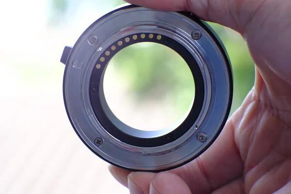 Hand Holding Camera Lens Blurred Trees Background — Stock Photo, Image