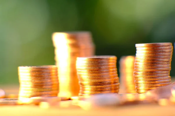 Coins stacked background and advertising coins of finance and banking, increasing columns of gold coins on table,financial success