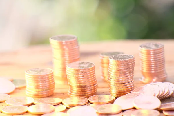 Coins stacked background and advertising coins of finance and banking, increasing columns of gold coins on table,financial success