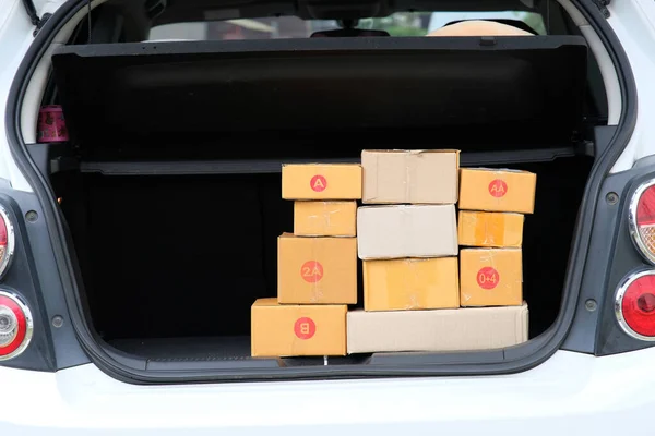 cardboard boxes inside of the car, delivery