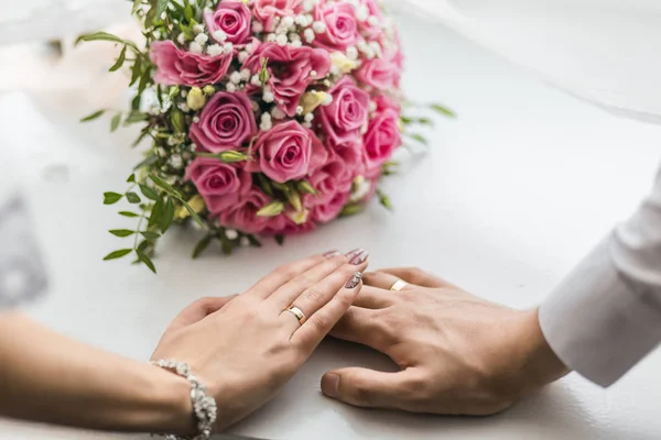 Young married couple holding hands, ceremony wedding day