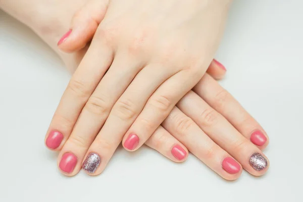 Hands with long artificial manicured nails colored with red nail polish — Stock Photo, Image