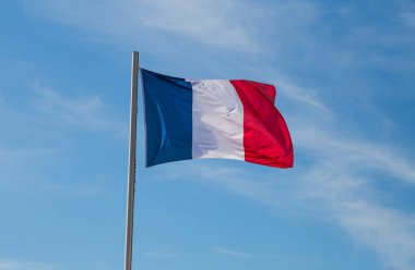 French flag under a blue sky background clipart