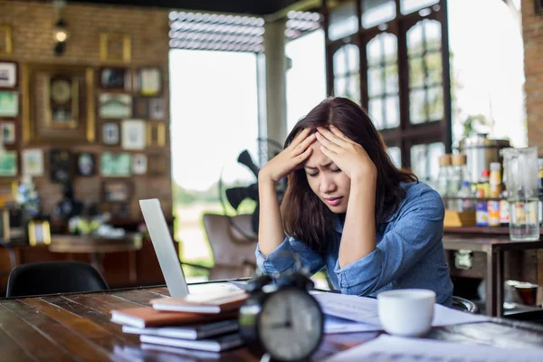 stock image Young woman sitting in a cafe with her laptop, Stressful for work.