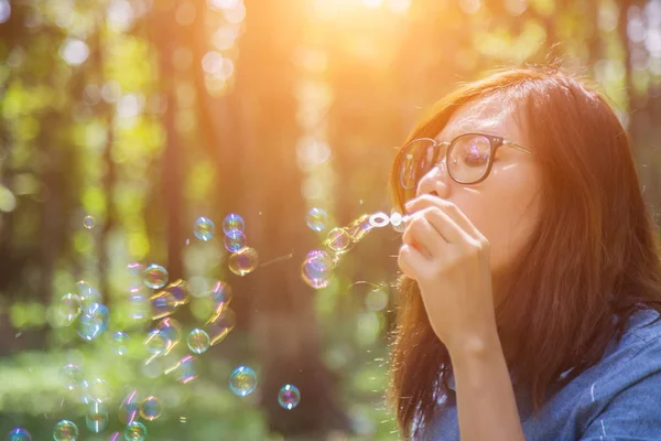 stock image a beautiful woman blowing bubbles