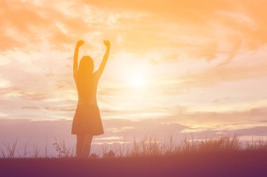 Güzel bir arka plan için dua eden bir kadın silueti.