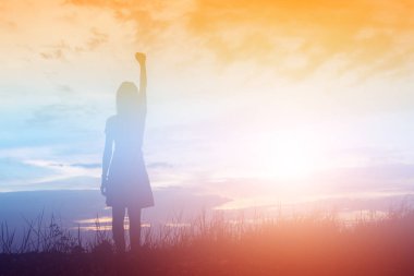 Güzel bir arka plan için dua eden bir kadın silueti.