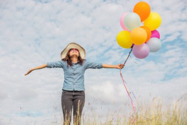 Güzel kız sahilde balonlarla atlama
