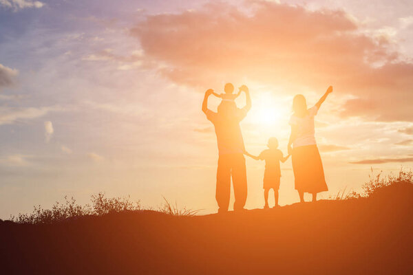 Happy family dancing on the road in the sunset time. Evening party on the nature