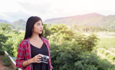 Vintage Fotoğraf makinesinin güzel kadınlar fotoğraf ayakta el holding retro gündoğumu, rüya yumuşak tarzı ile
