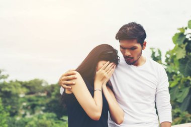 Genç yakışıklı erkek arkadaşı, sarılma o üzgün ve kızgın.