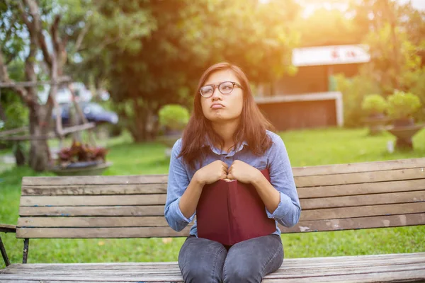 Bir kitap okuma bahçede oturan bir kadın.