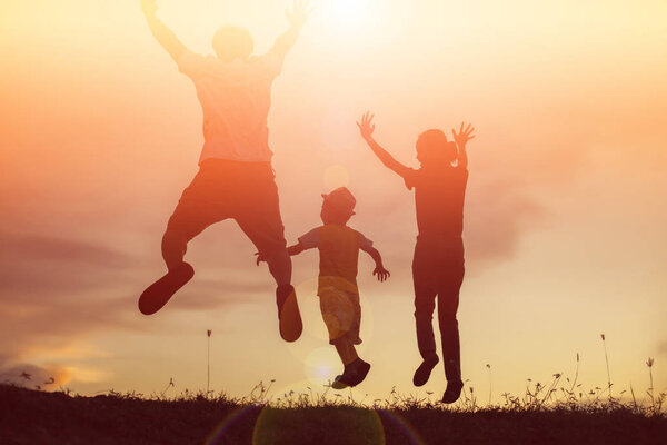 silhouette of a happy family and happy time sunset