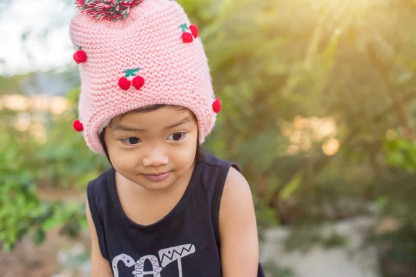 Mor çiçek alan güneş gün arasında duran küçük şirin Asyalı kız. Doğa ile zevk özgürlük.