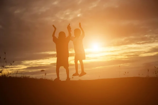 silhouette of a happy children and happy time sunset