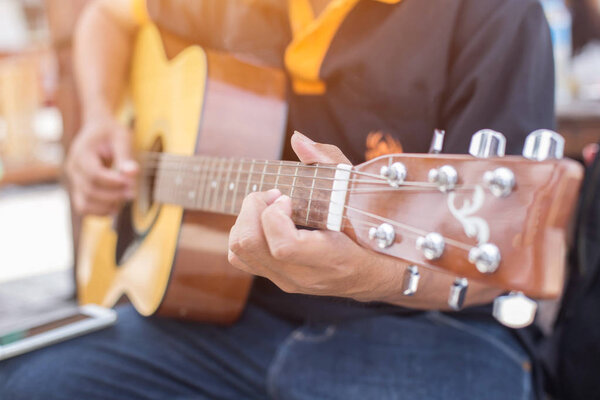 Close up of man hand playing guitar