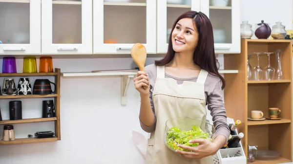 Woman cook at the kitchen, soft focus background