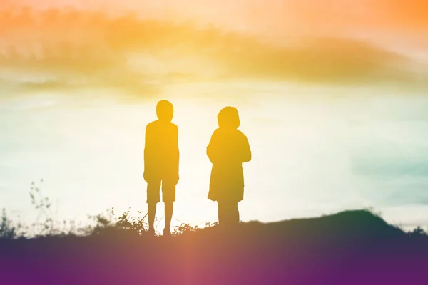 silhouette of a happy children and happy time sunset