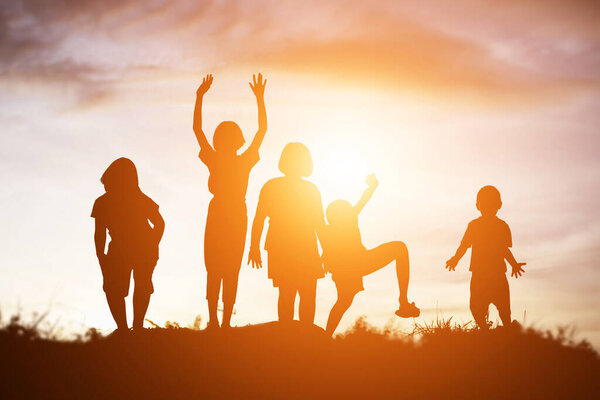 silhouette of a happy children and happy time sunset