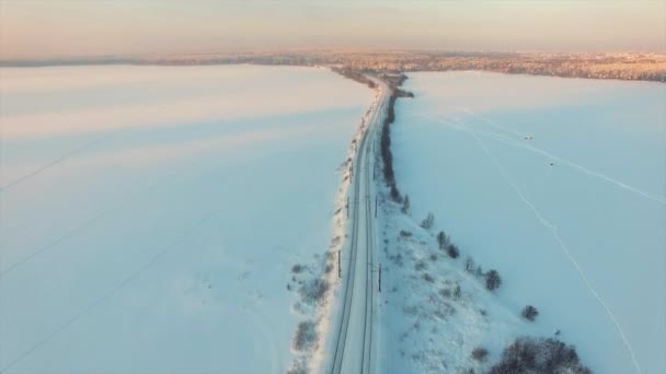 Flying above rural winter landscape at sunset. — Stock Video