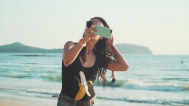 Sahilde selfie çeken mutlu kadın