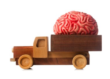 Wooden truck carries a rubber brain, metaphor for brain drain. clipart