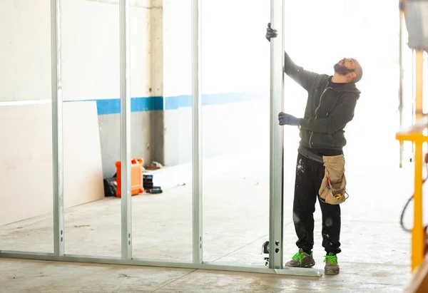 Worker builds a plasterboard wall. — Stock Photo, Image