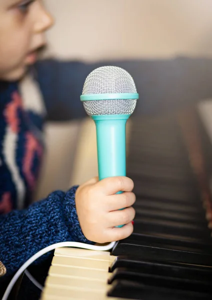 Girl toddler, piano and toy microphone. — Stock Photo, Image
