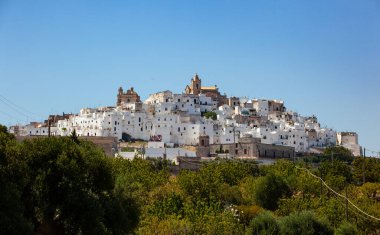 Ostuni, İtalya - 14 Ağustos 2014: Tepedeki beyaz ve eski Ostuni şehrinin panoramik manzarası ve üstünde katedral.