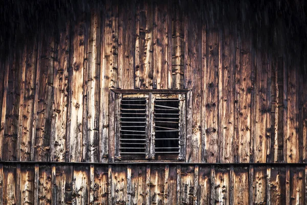 Detail of wood texture of an old cabin during a rainy evening
