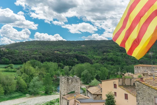 Catalan flag over nice view of Besalu, small and medieval village in Girona, Catalonia