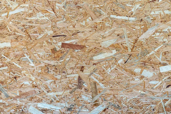 Sheet of plywood with fragments of compressed sawdust. Top view of veneer