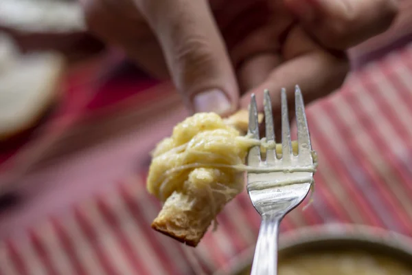 Guy eats with fork traditional turkish food with butter and cheese for breakfast time
