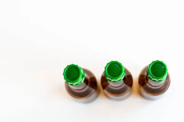 Top corner shoot of three line positioned small alcohol bottles brown colored