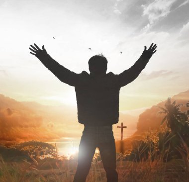 Silhouette of Christian prayers raising hand while praying to the Jesus clipart
